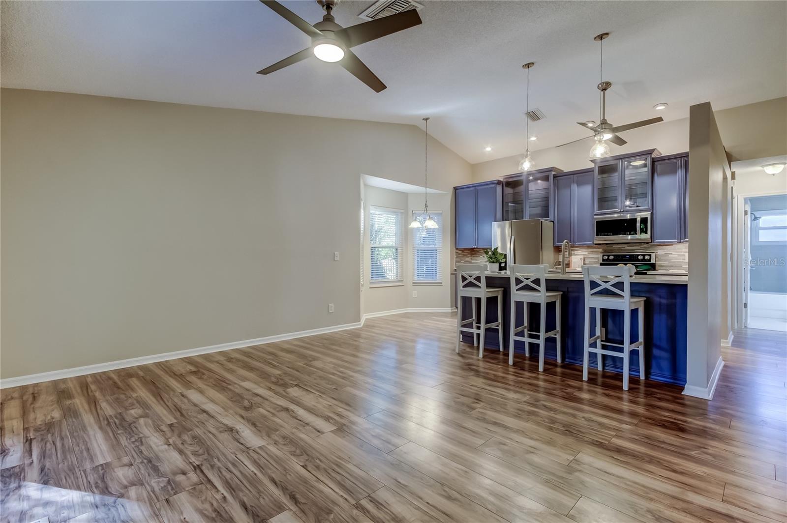 24. Family is Nearby as the Chef Preps for Dinner in Kitchen (13.4' x 22.7)' - Open Concept Living We All Want!!