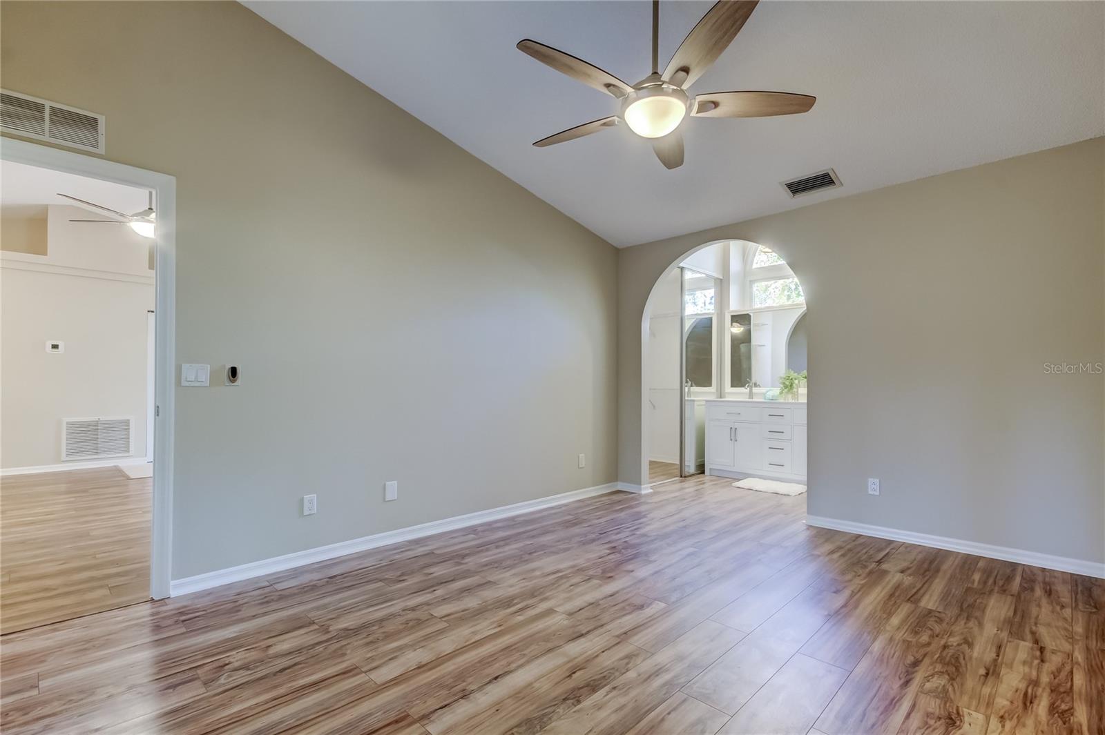 27. Primary Bedroom! Features Walk-in Closet, Luxurious Bathroom, 10' Vaulted Ceiling, & Sliders to Lanai (12.7 ft x 15 ft)!!