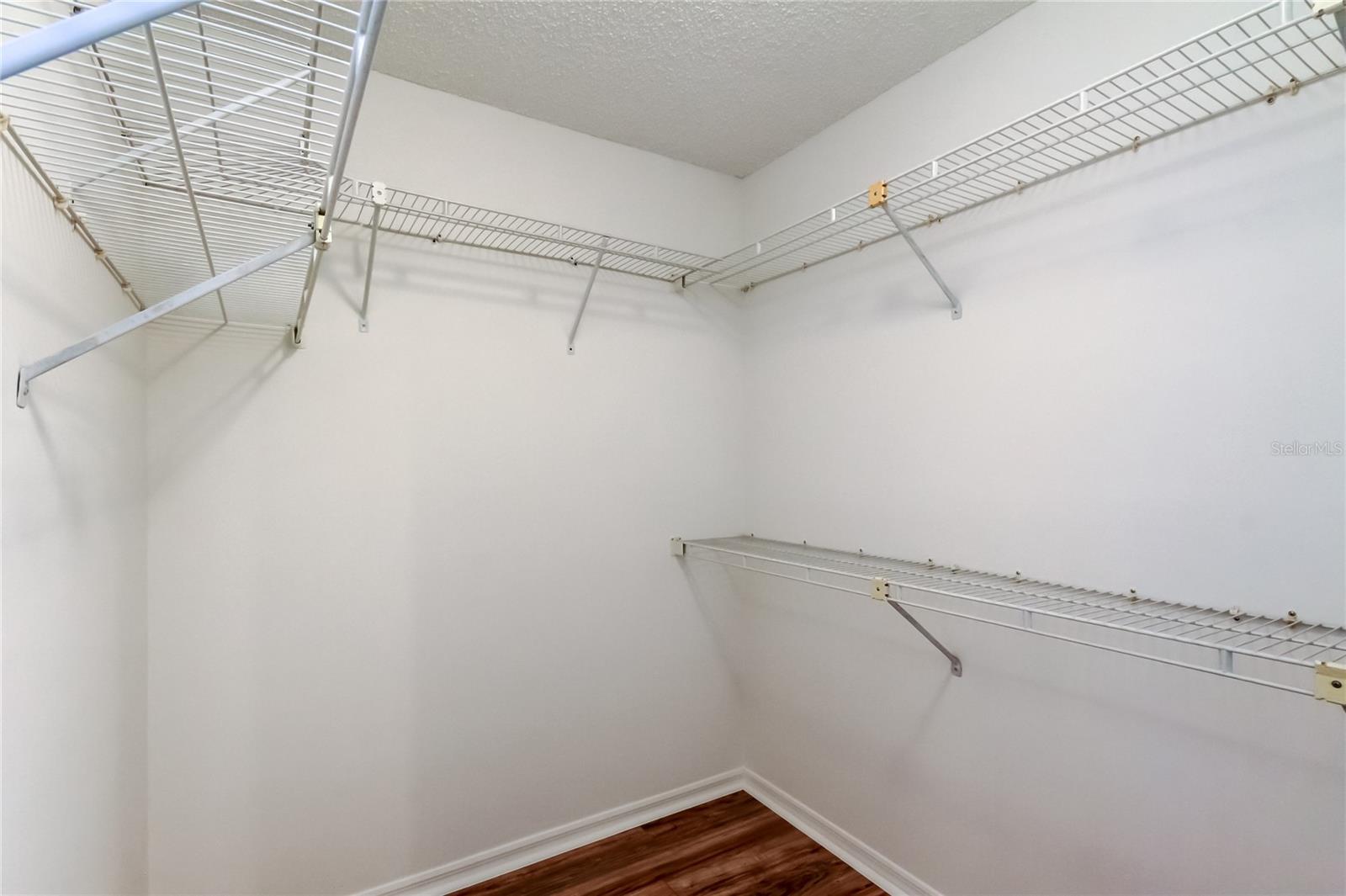 34. Spacious Walk-in Closet (5.10' x 6.1') in Primary Bedrm w Room for Shelves Allows  Space for ALL to be Happy!!