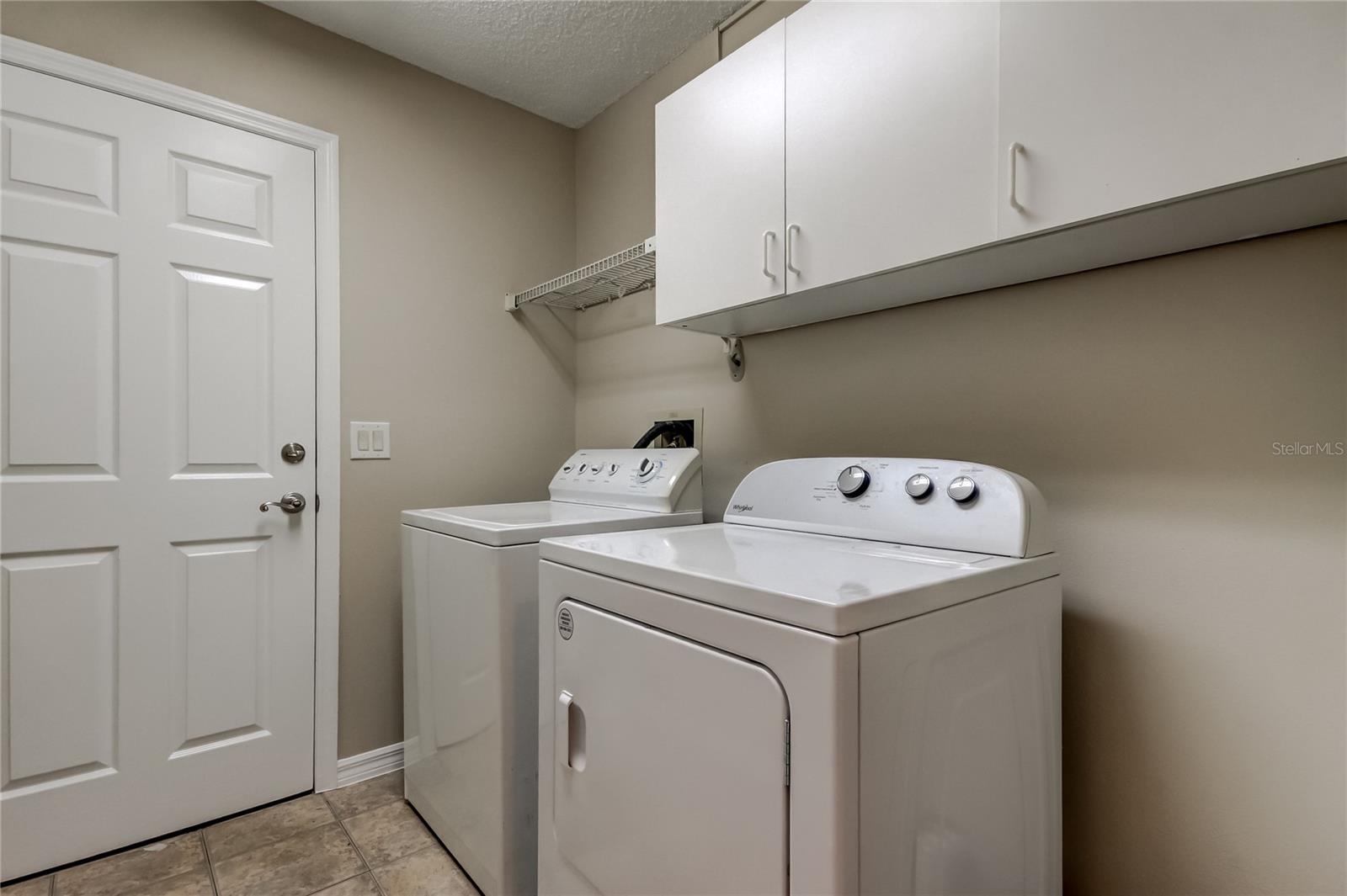 53. Laundry Room is Pass Thru from Garage into Home (7.6' x 6.1') Functional w Storage Cabinets!!