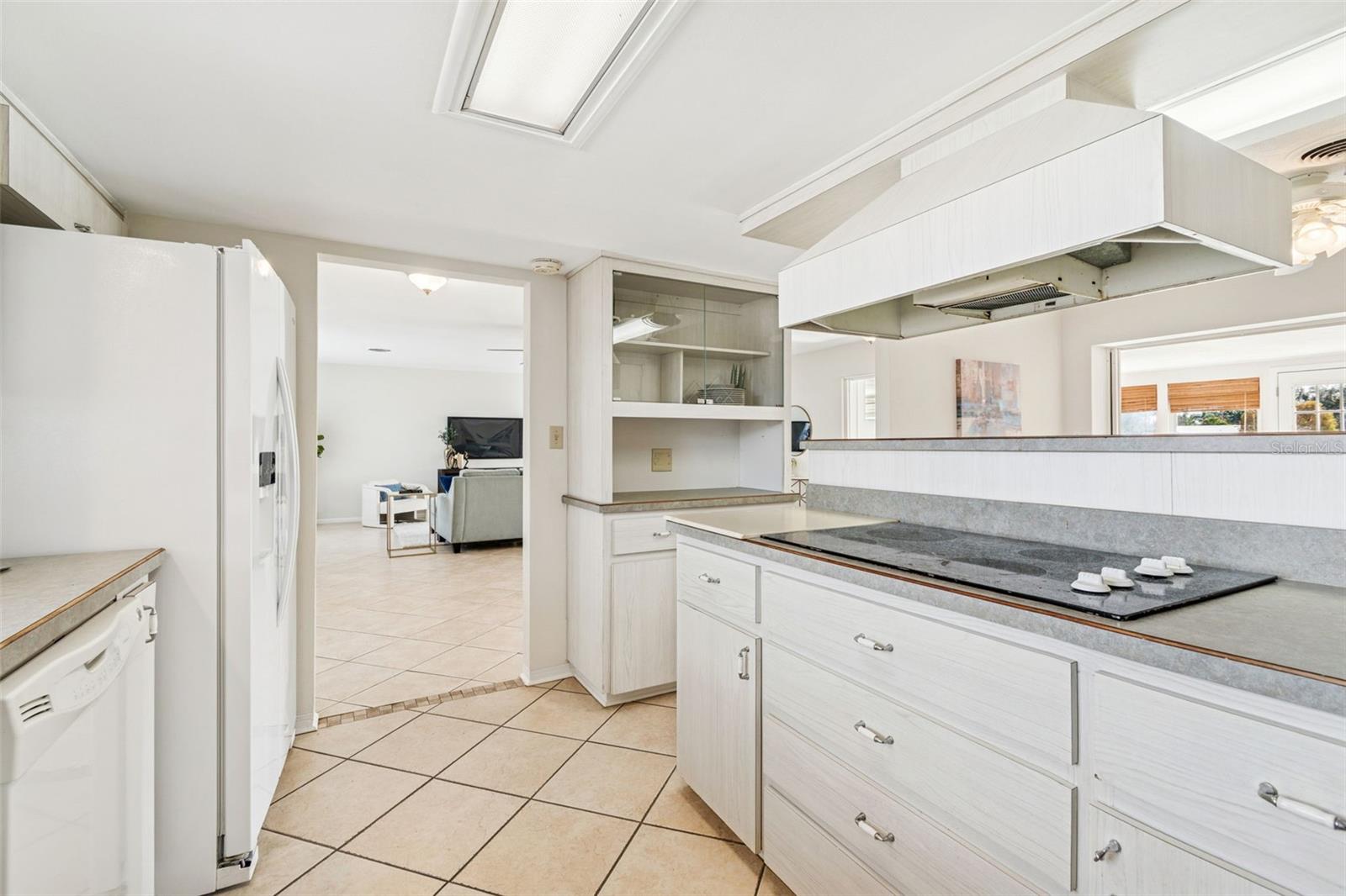 Island cooktop with exterior vented hood and plenty of storage