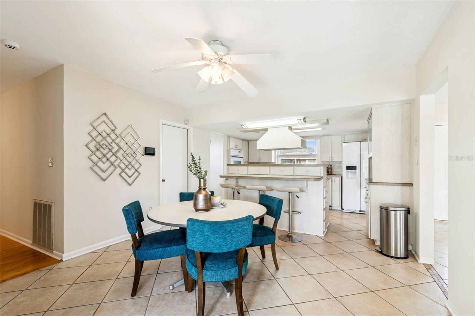 Eat-in kitchen adjacent to dining area overlooking lake
