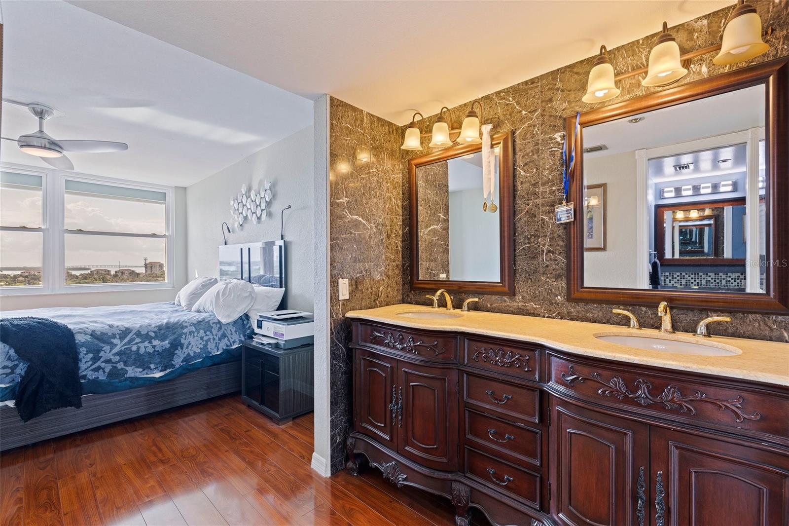 SECOND BEDROOM HAS A DOUBLE SINK VANITY, WALK IN CLOSET AND ENSUITE HANDICAP ACCESSIBLE BATHROOM