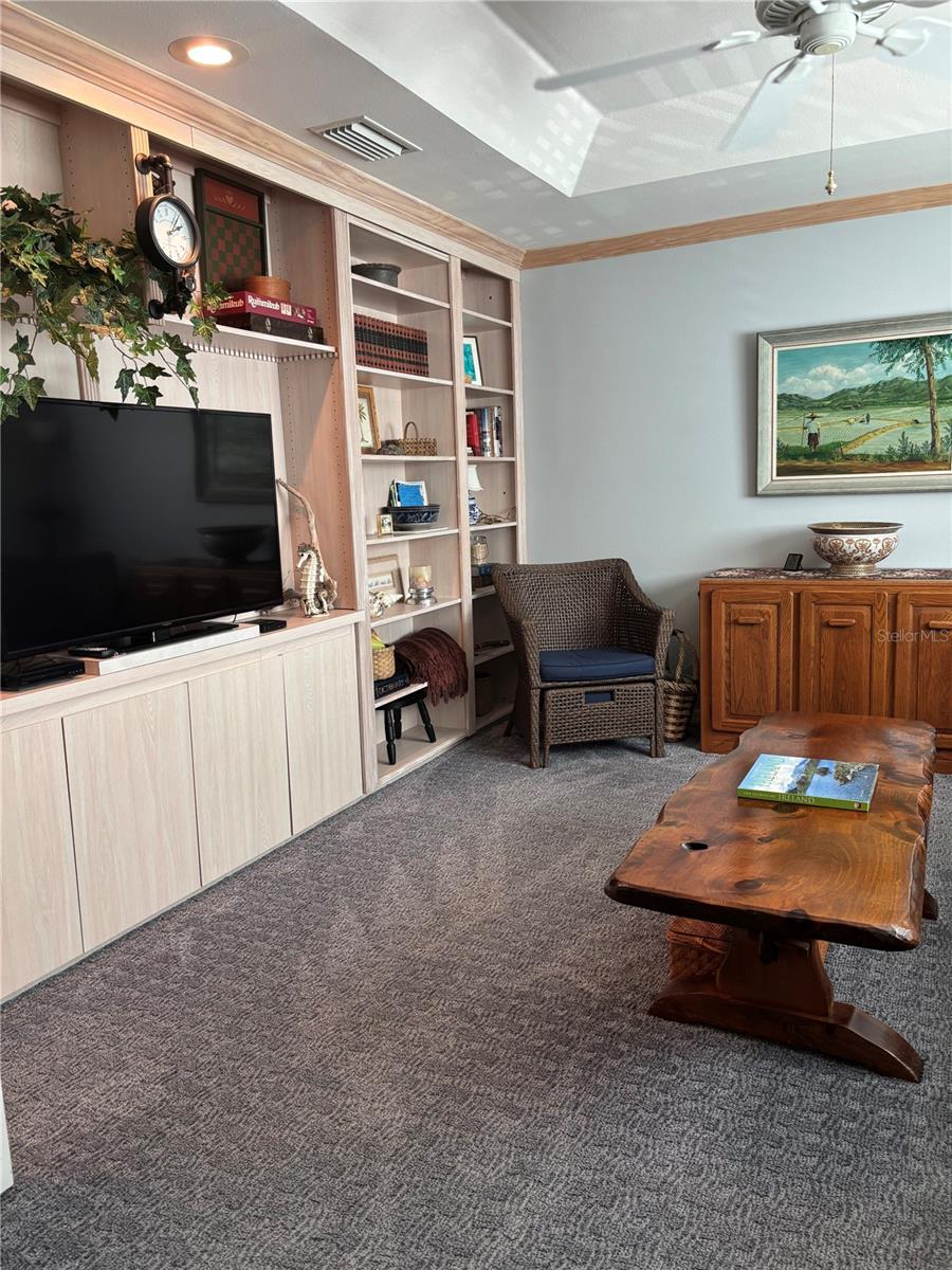 Office with hidden space behind book shelf!