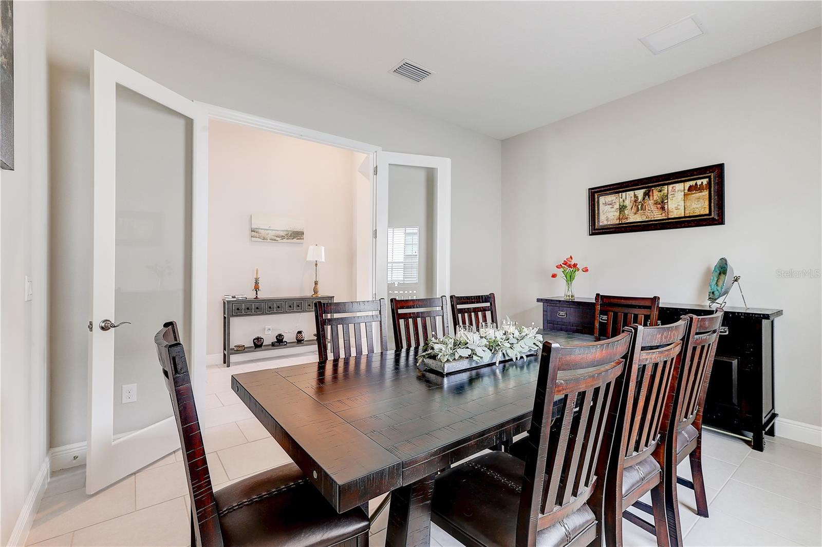 flex space with glass french doors / office / bonus room - currently being used as a formal dining room