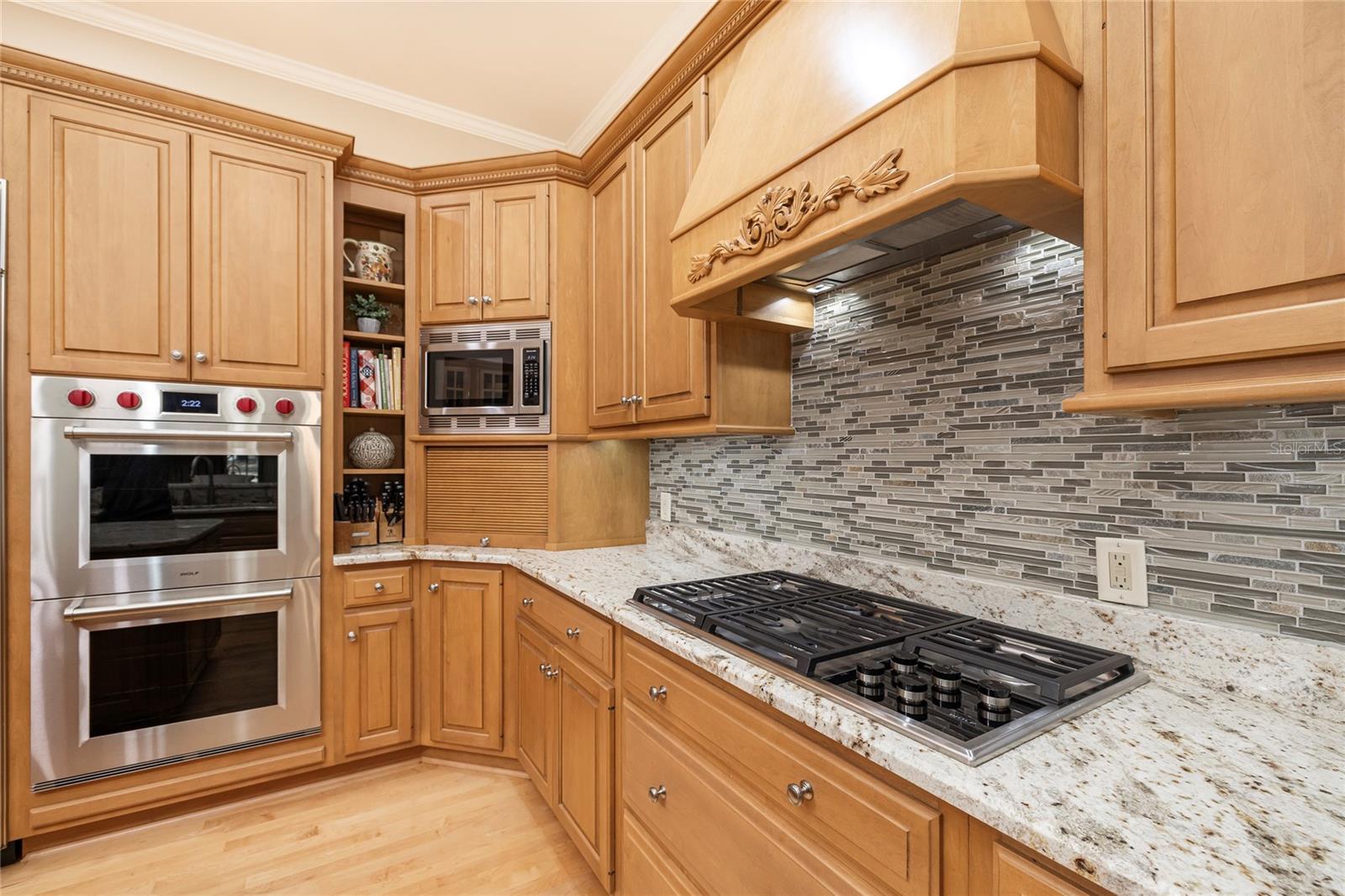 Double oven and Wolf natural gas cooktop.