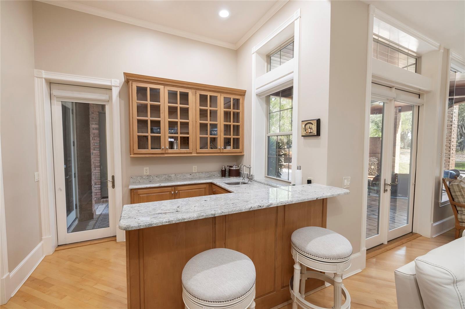 Wet bar with ice maker, beverage refrigerator, and filtered water.