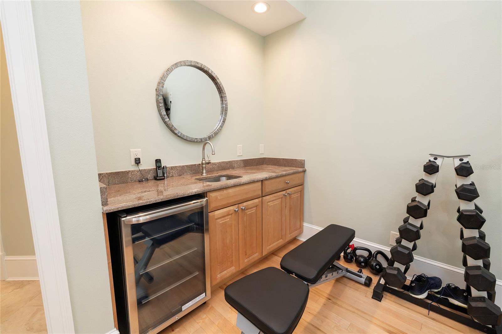 Kitchenette in exercise room which could also be an in-law suite. There is a full bath and a walk-in closet in this suite.  It also has French doors to the pool area.  There is a covered entrance separate from the main house.