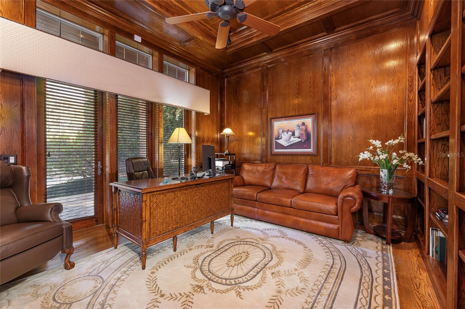 The office enjoys rich handcrafted wood panelling and ceiling and shares a gas fireplace (no flue) with the formal living room.