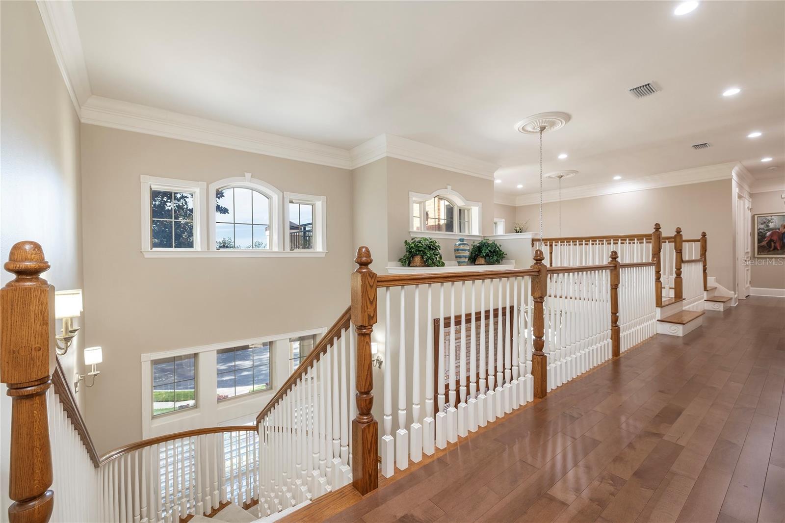 Second floor hallway to all bedroom suites opens to the first floor. Elevator at the end of the hallway which also goes to all levels. The elevator lands in front of the entry to the primary suite.