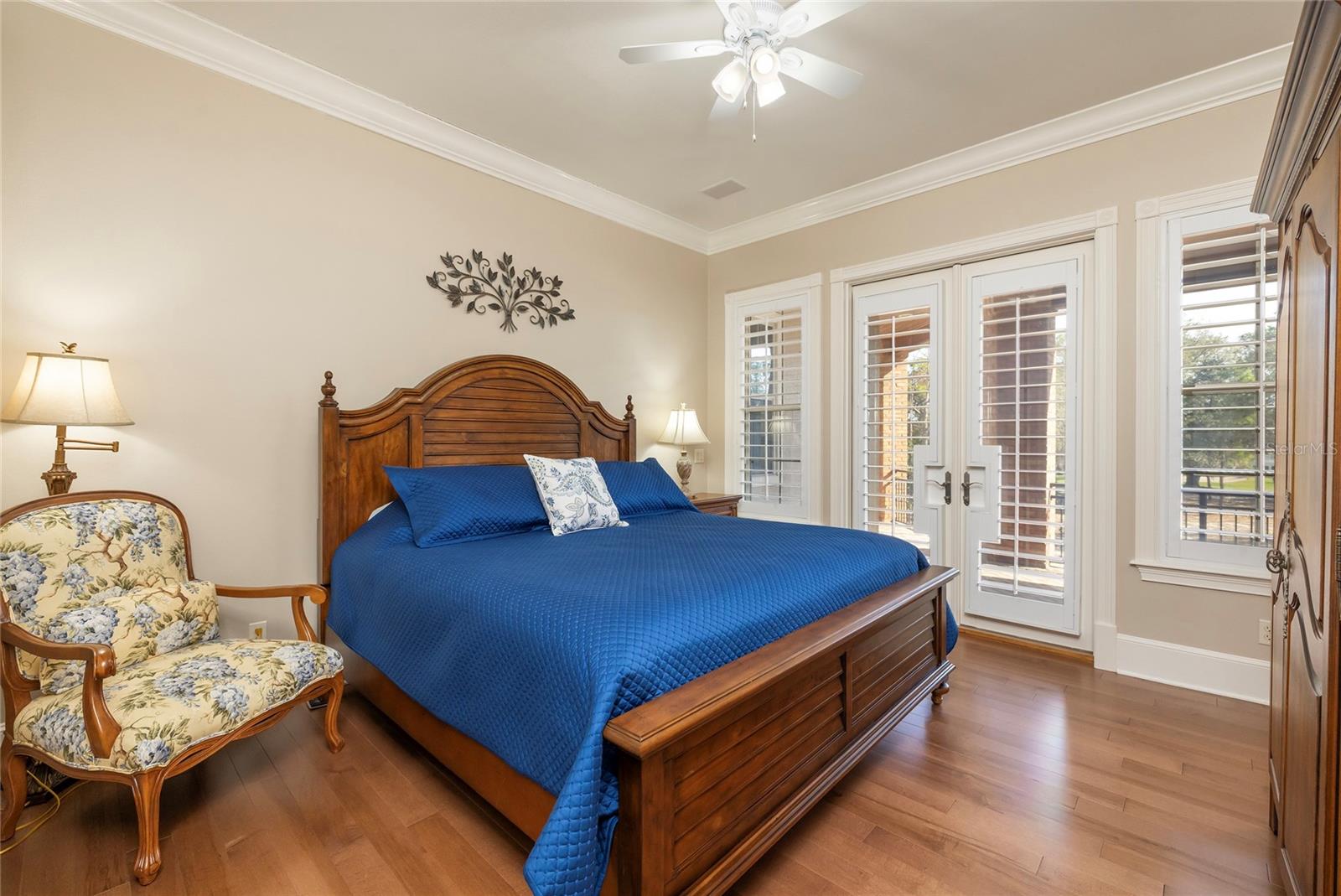 Guest bedroom with French doors to the covered balcony, walk-in closet, and ensuite bath.
