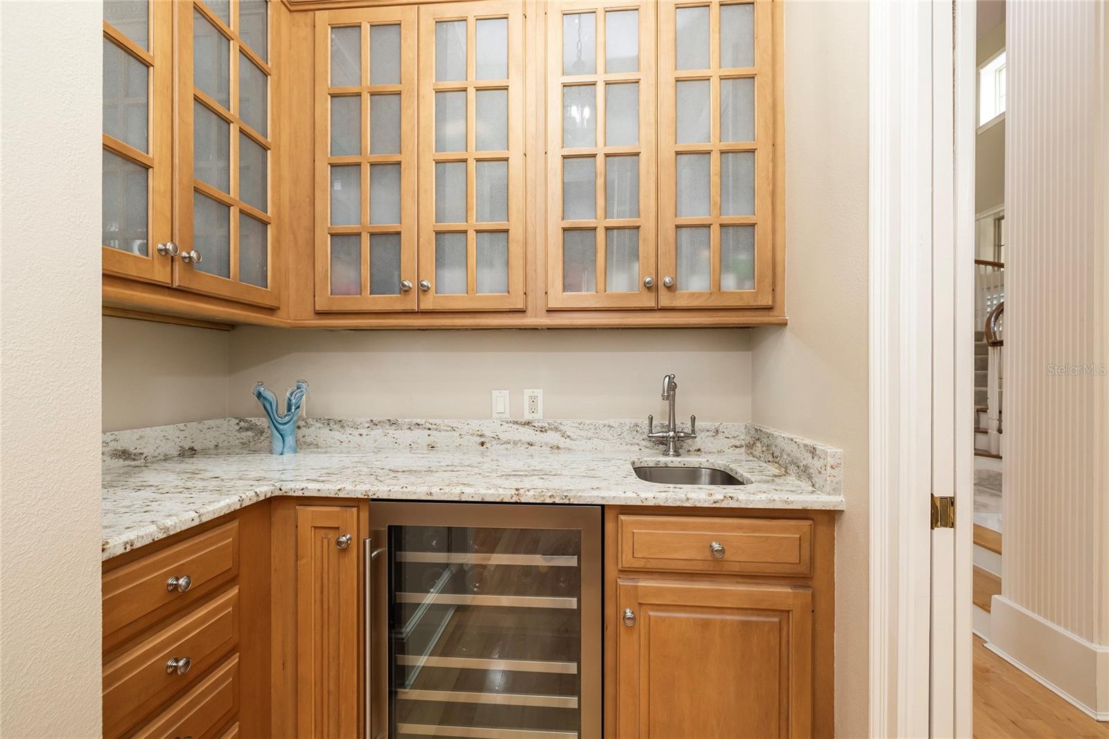 Butler's pantry has a wine refrigerator.
