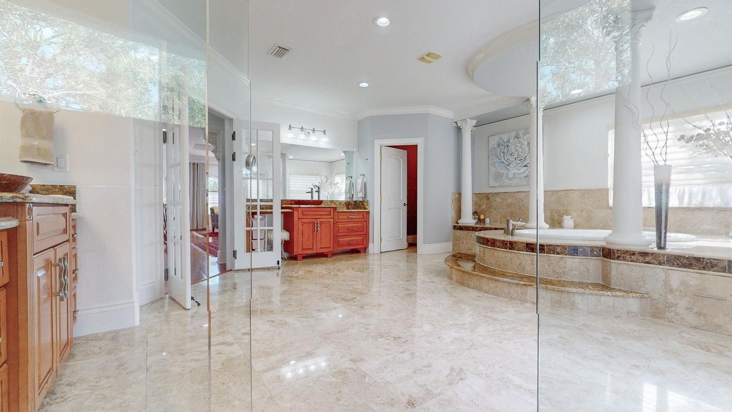 Primary Bedroom with Sitting Room, private balcony overlooking Tampa Bay, En-suite Primary Bathroom with oversized Walk in Closed