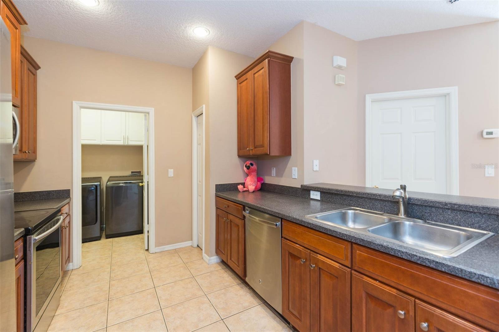 Kitchen with long countertops and separate laundry