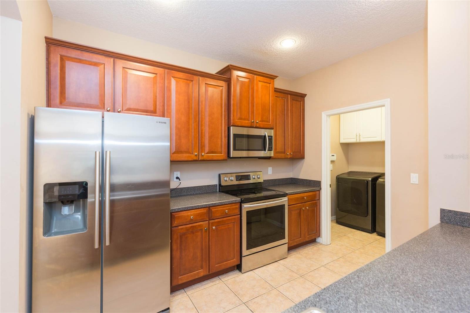 Stainless appliances and raised panel wood cabinets