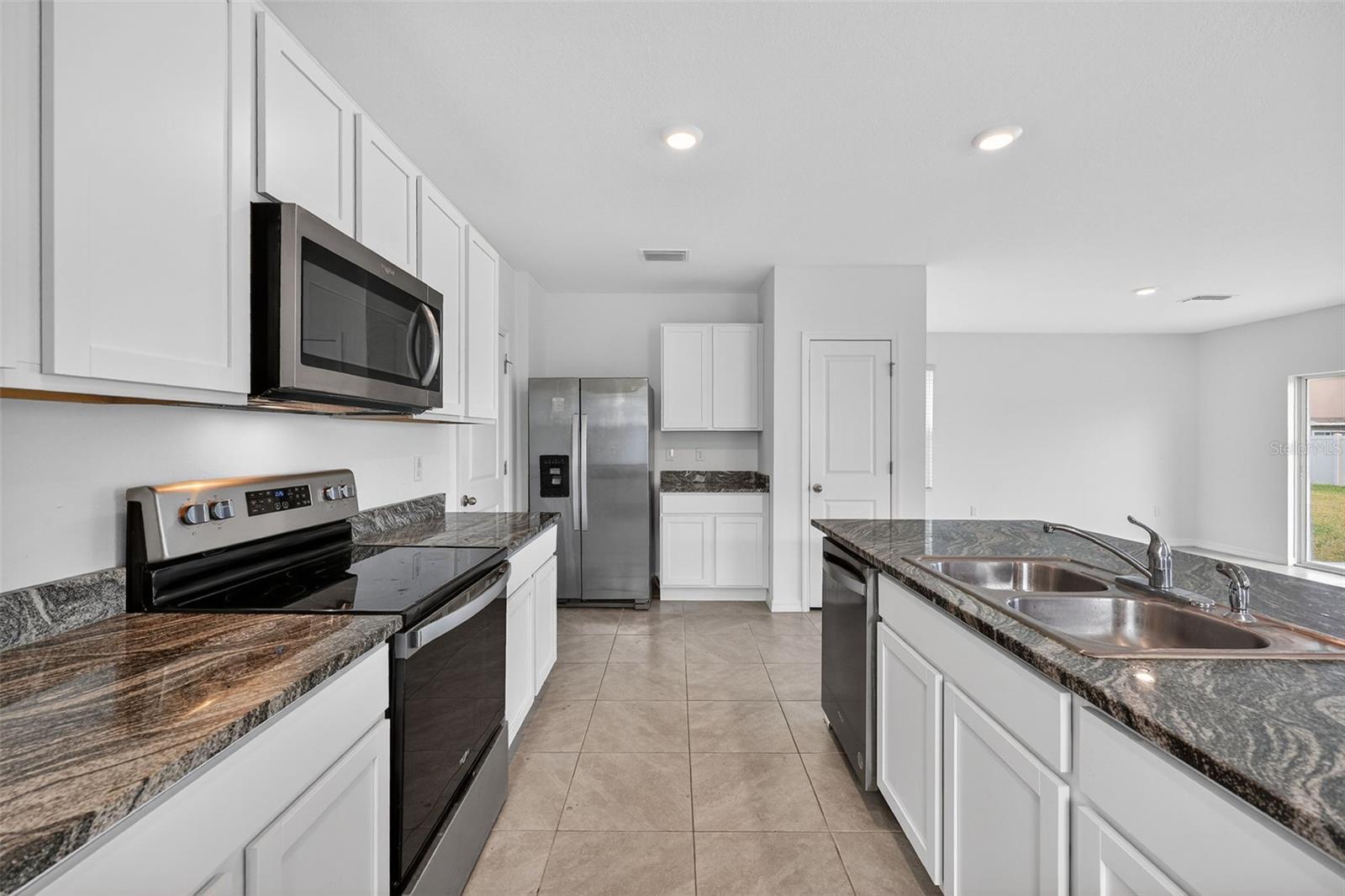 Stainless Appliances and large work Island with Granite Countertops
