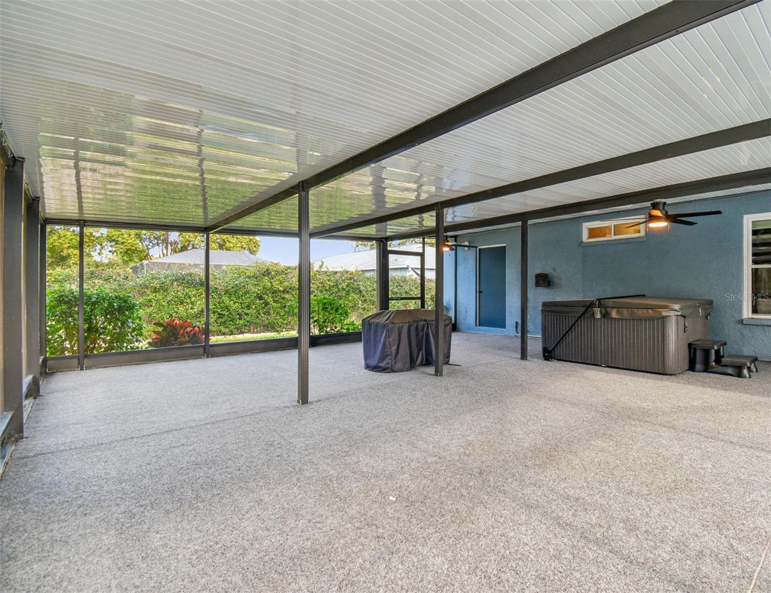 rear covered patio with hot tub