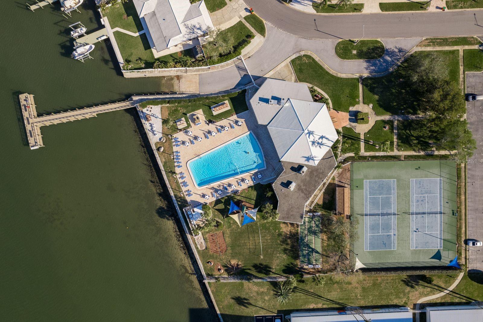 North view of boat ramp, dock, large pool that is heated or cooled keeping water at a constant temperature winter and summer, shuffle board and tennis courts.