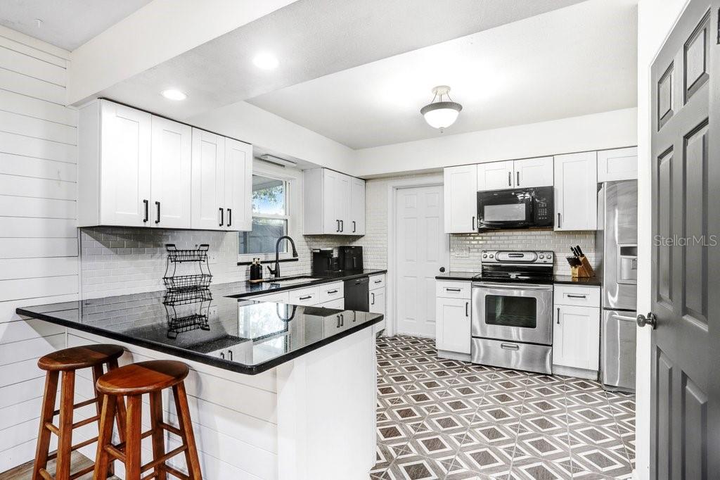Beautiful updated kitchen with 42" cabinets, granite countertops, Back splash, Mosaic Tile  and stainless appliances.