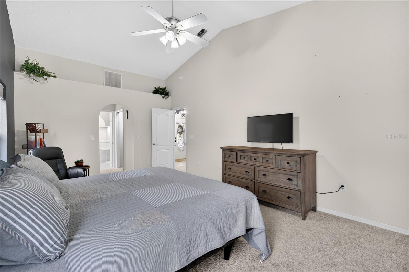 Door to the right leads to the Living Room. Archway on the left leads to en-suite bathroom, with 2 walk-in closets in the hall leading to the bathroom