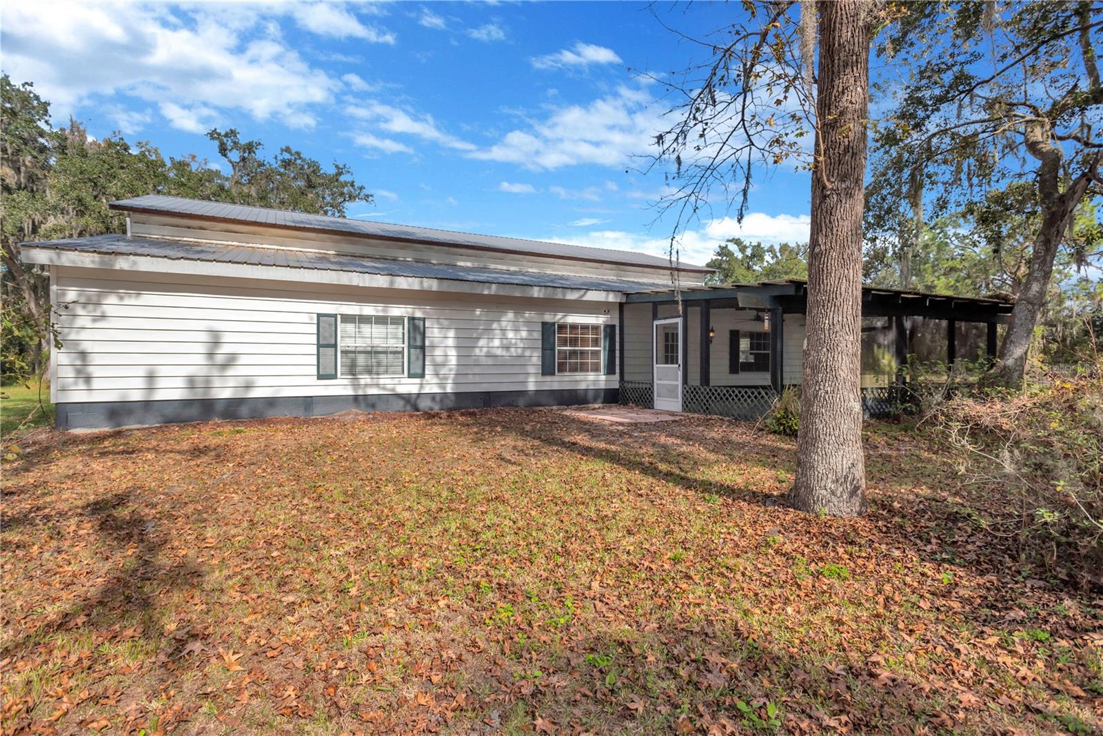 4 bed, 1 bath country estate east of Valrico on 15 acres and with a 1,896 sq ft garage with 15-foot roll-up door.