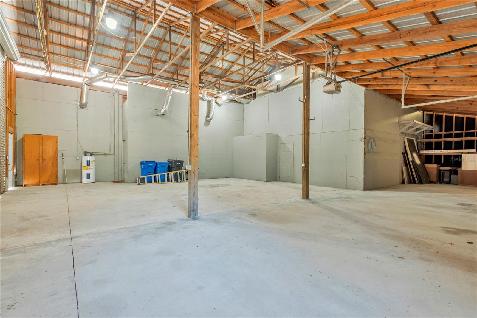 Solid construction is evident throughout, featuring 2x8 framing, thick pole-barn beams, and a durable metal roof—making this property ideal for a small business, workshop, or homestead