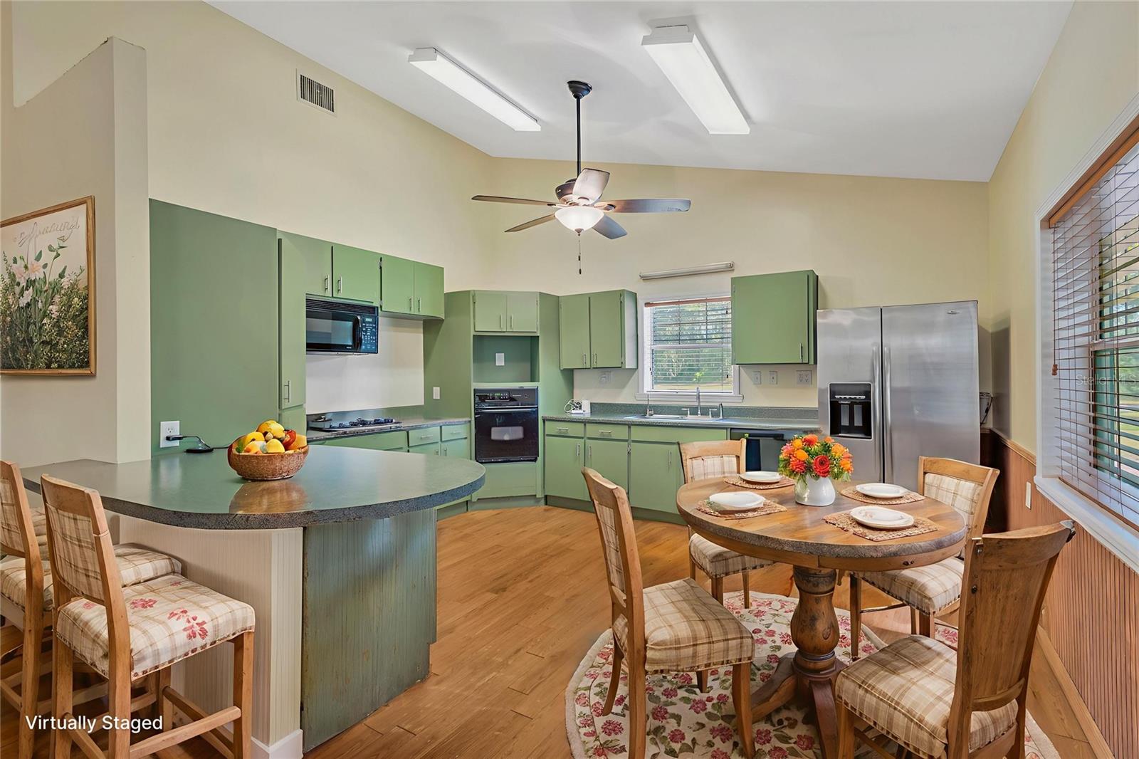 The kitchen has a breakfast bar for additional seating and room for a casual dining table overlooking the wooded countryside.