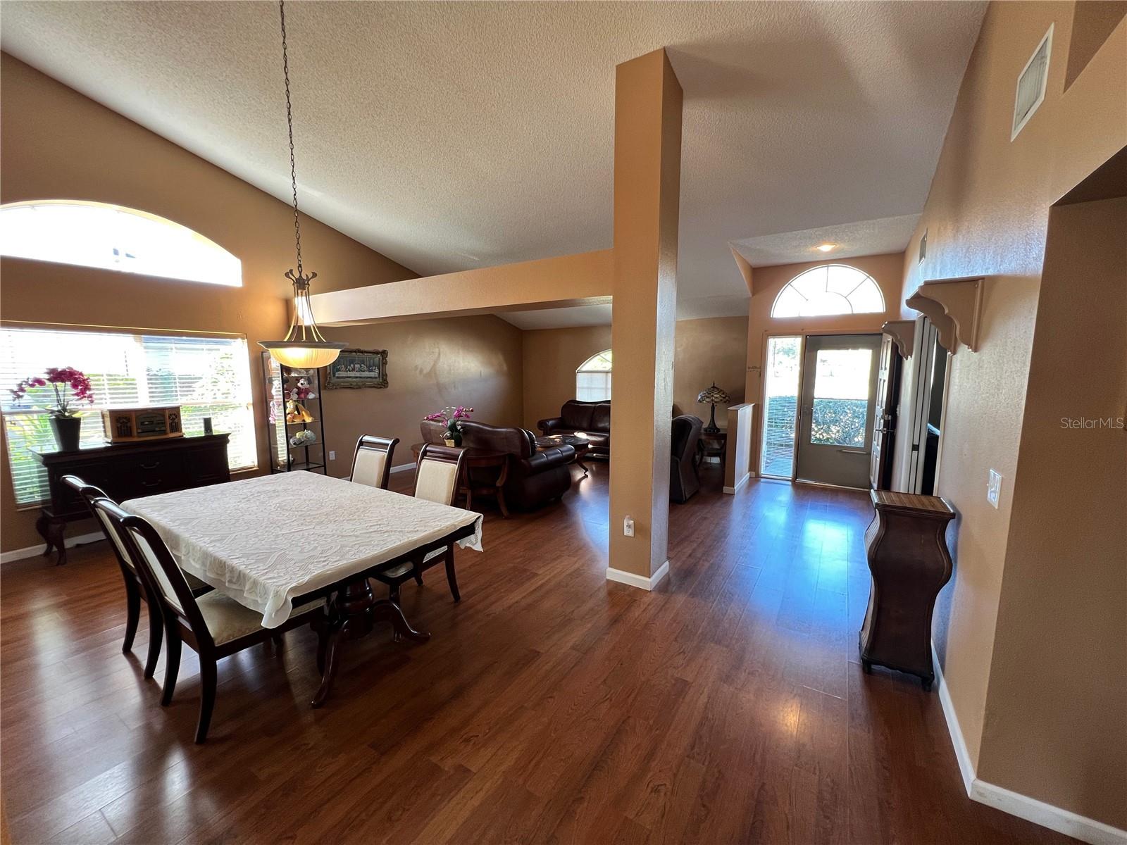 View of dining area, living room, and front door entry.