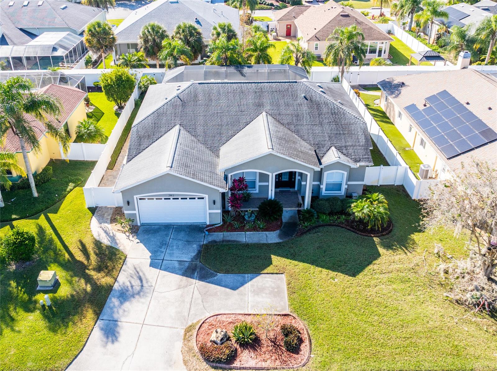Aerial view of home with vinyl fence leads to pathway to clubhouse.  Each home has a vinyl fence and private gate.  Roof is only 7 years old.  2018