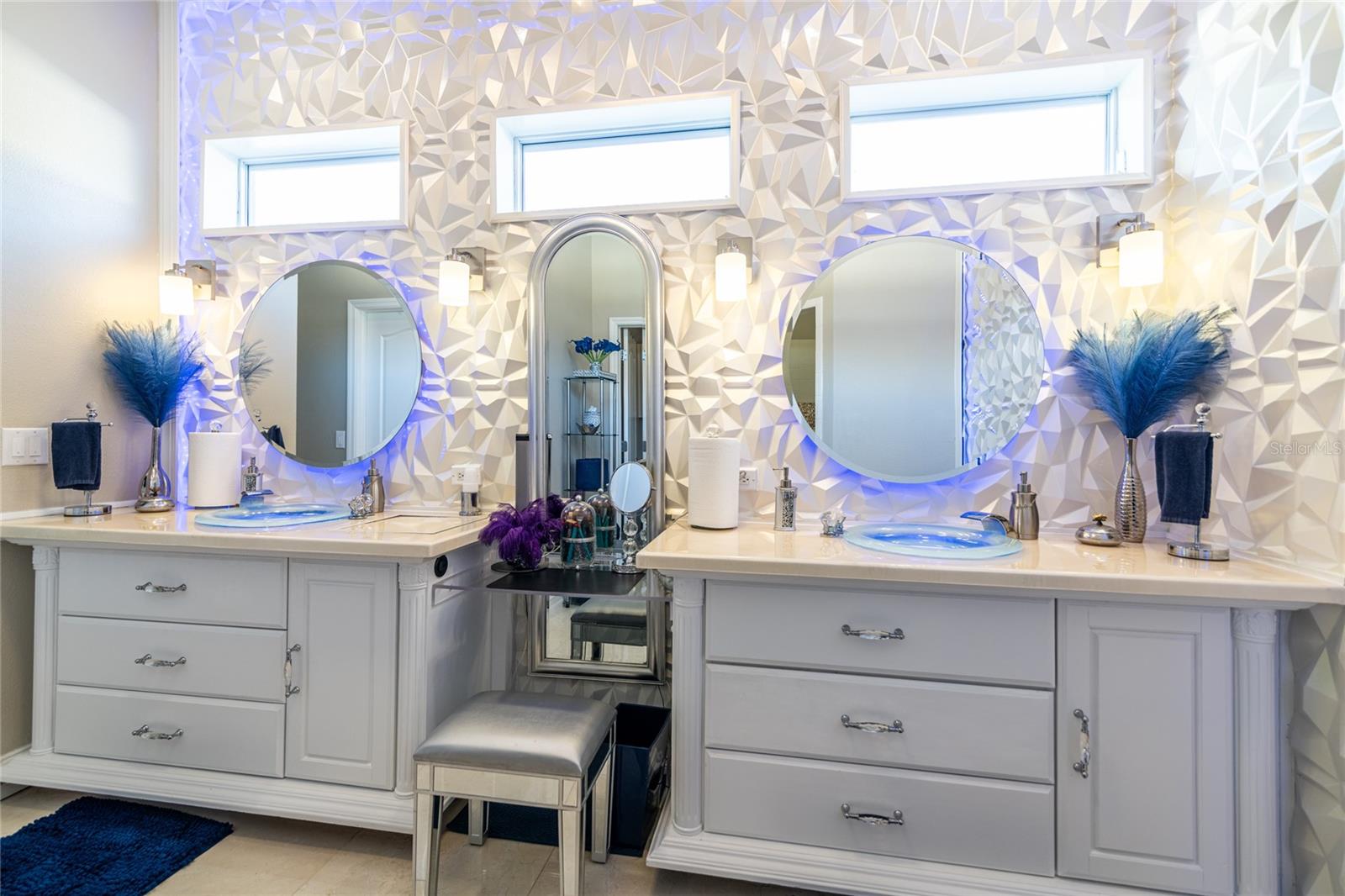 Master bathroom with lighted mirrors.