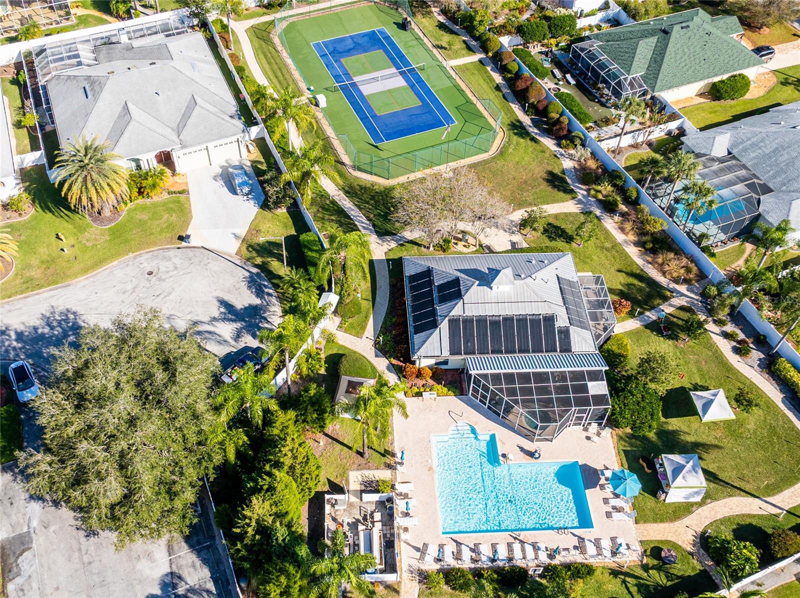 The Oasis clubhouse with pool, tennis/pickleball, hot tub, fitness center, kitchen and social gathering area.