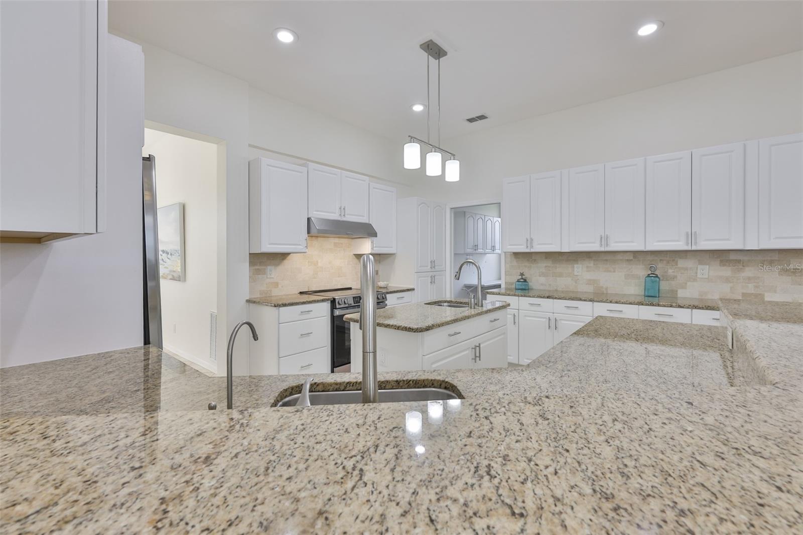 Remodeled Kitchen, New White Wood Cabinets & Handles Granite Countertops & Coordinating Backsplash Cabinets, New SS Appliances