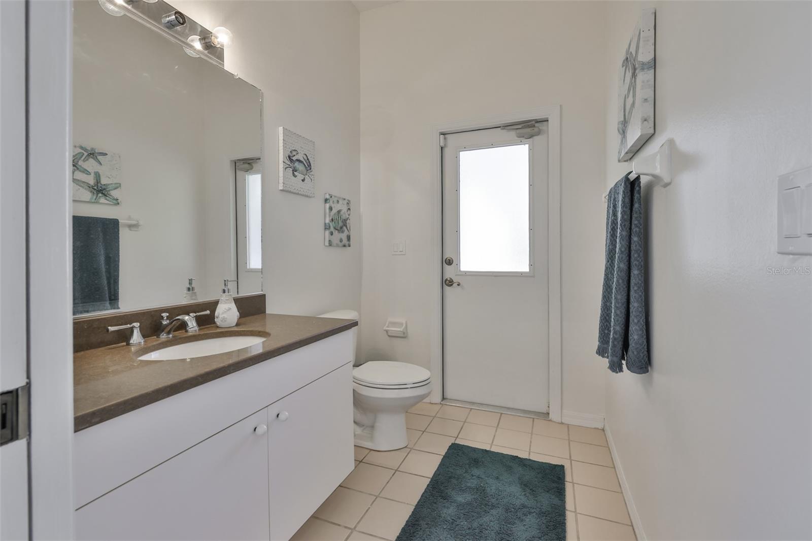 Spacious Guest Ensuite 1/2 Bath & Lanai Access, Pocket Door