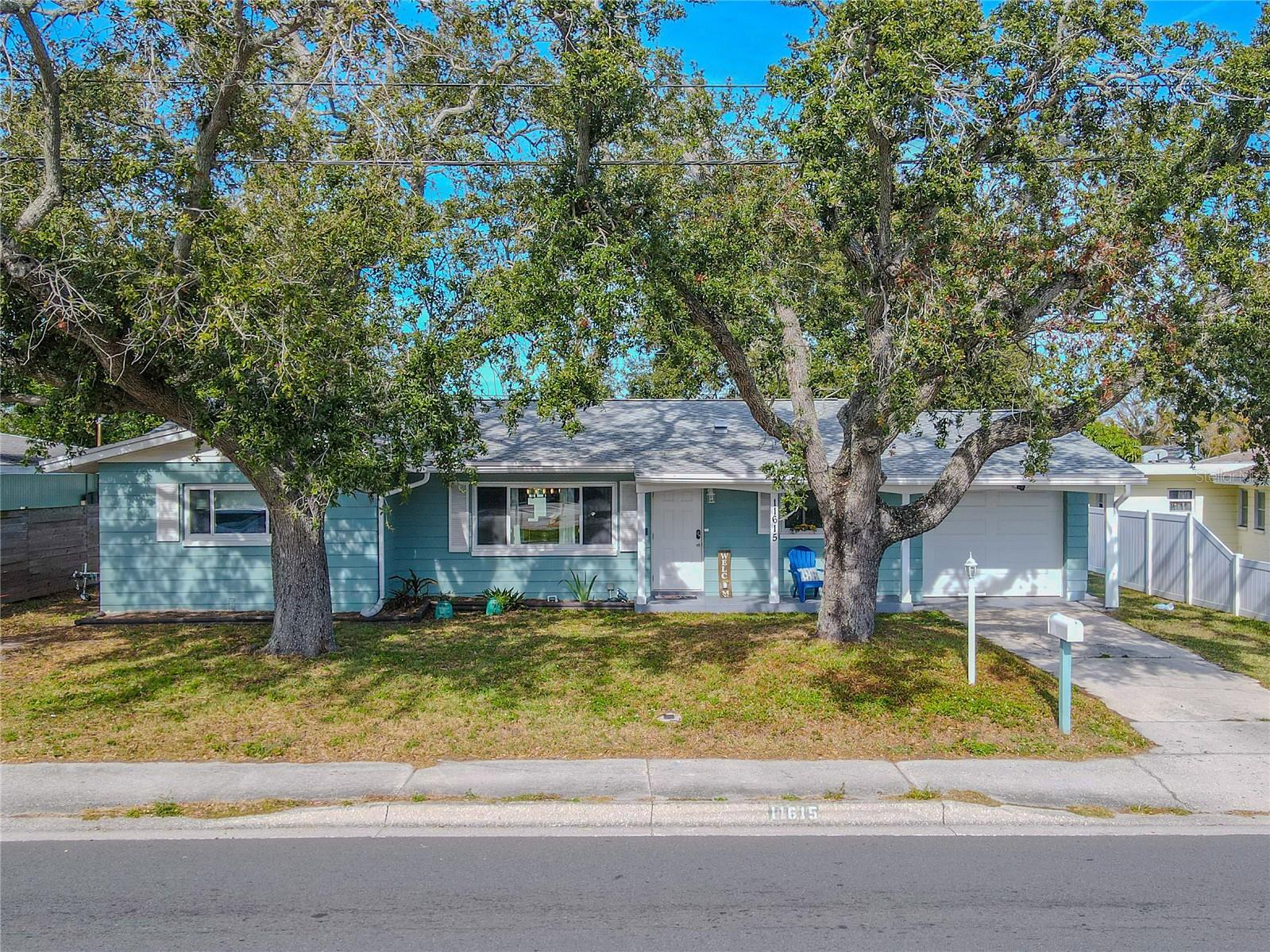 Charming single-story ideally located, Seminole home showcases a welcoming curb appeal with mature shade trees, a spacious driveway, and an attached garage.