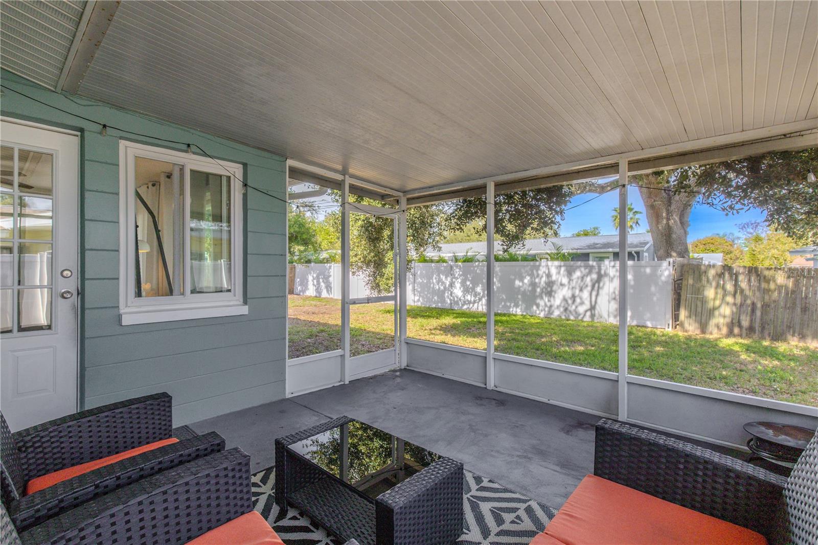 Relax in the screened 14.1 X 12.2 patio overlooking the fenced backyard—an ideal spot for morning coffee, evening breezes, and easy indoor-outdoor living.