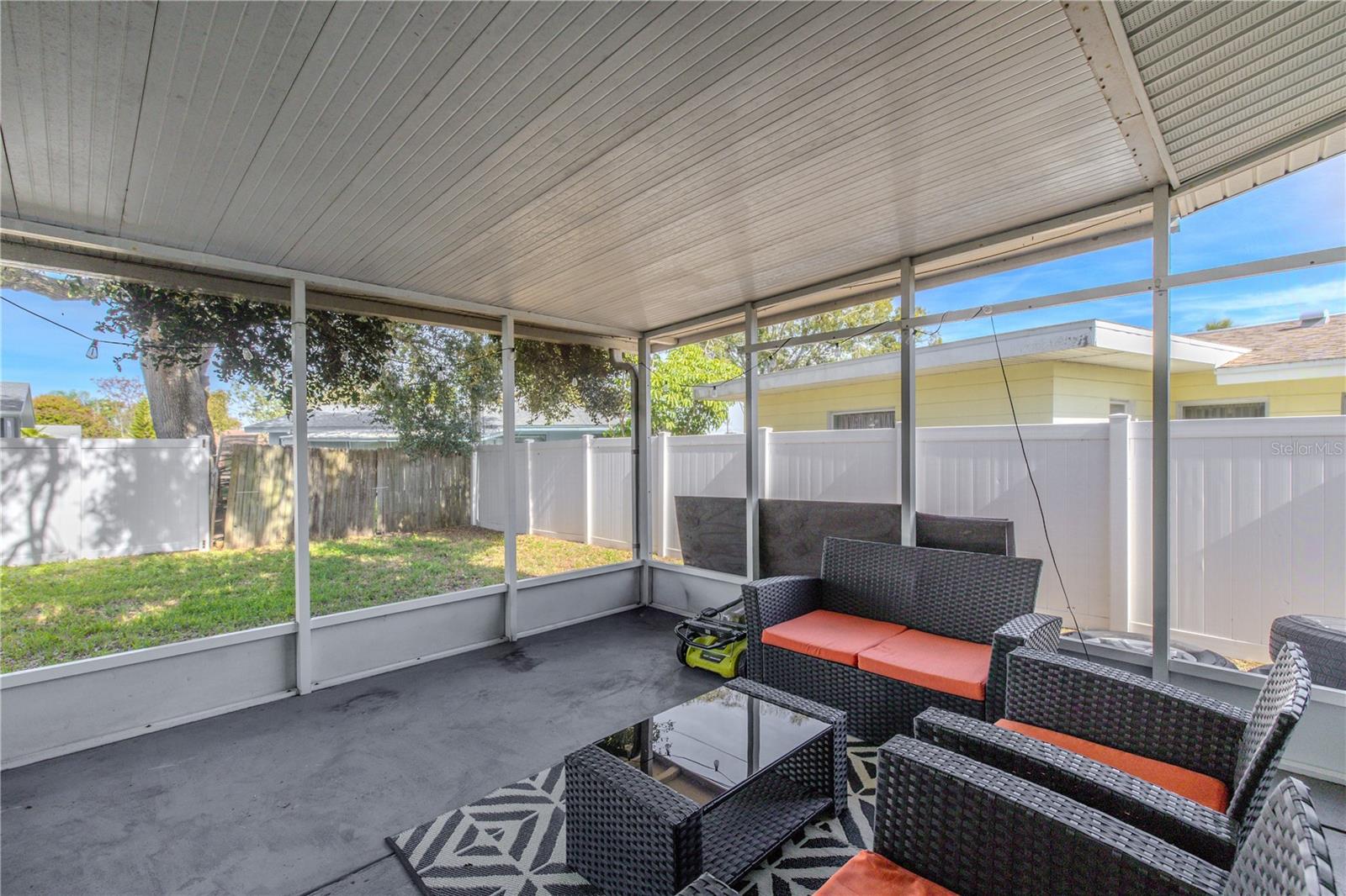 Screened patio offers a relaxing outdoor lounge space with views of the fully fenced backyard—perfect for year-round Florida living.