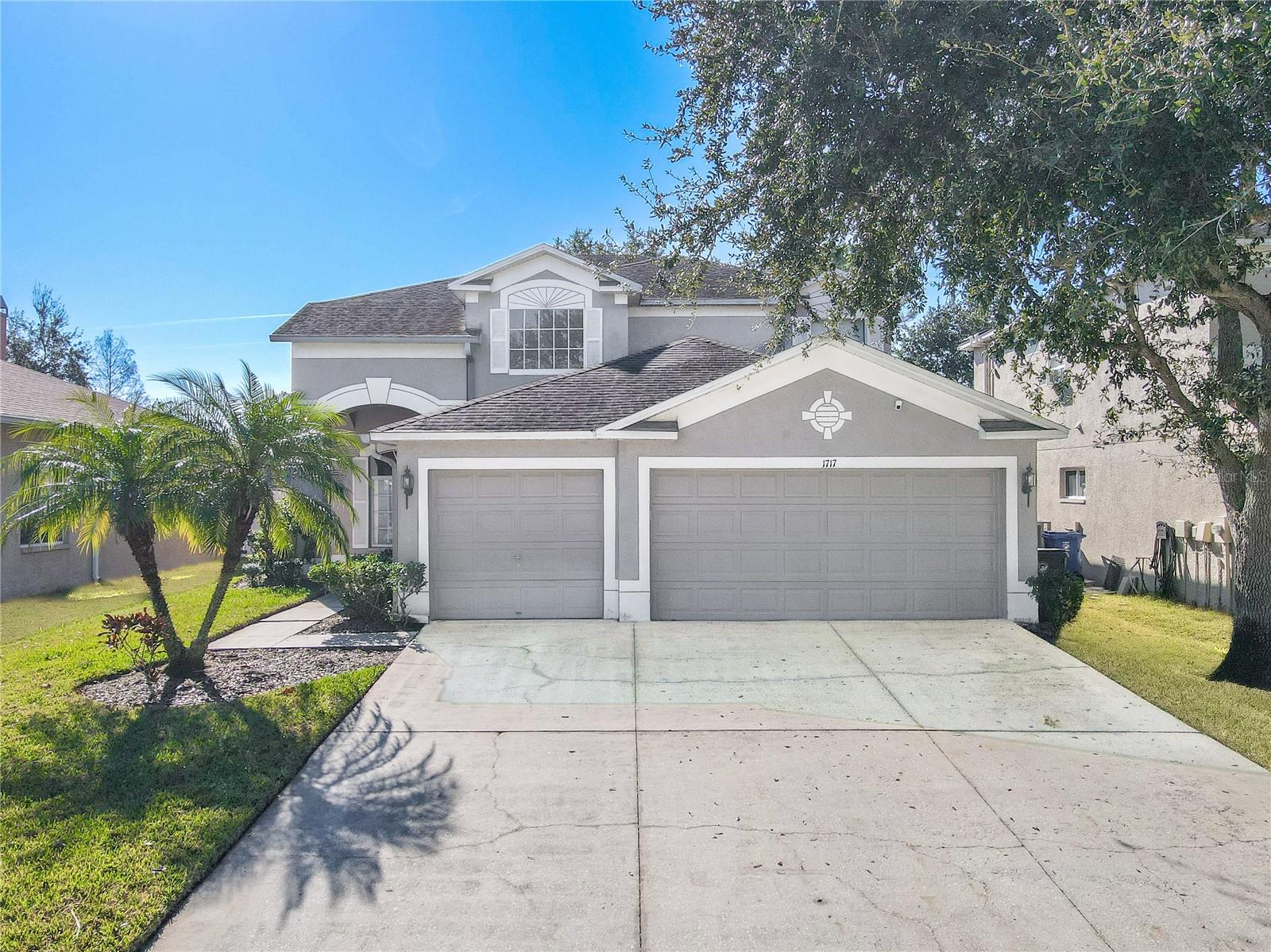 Inviting two-story 4 bedroom/3 bath home with a spacious multi-car garage, wide driveway, and charming curb appeal, enhanced by mature shade trees and easy-care landscaping.