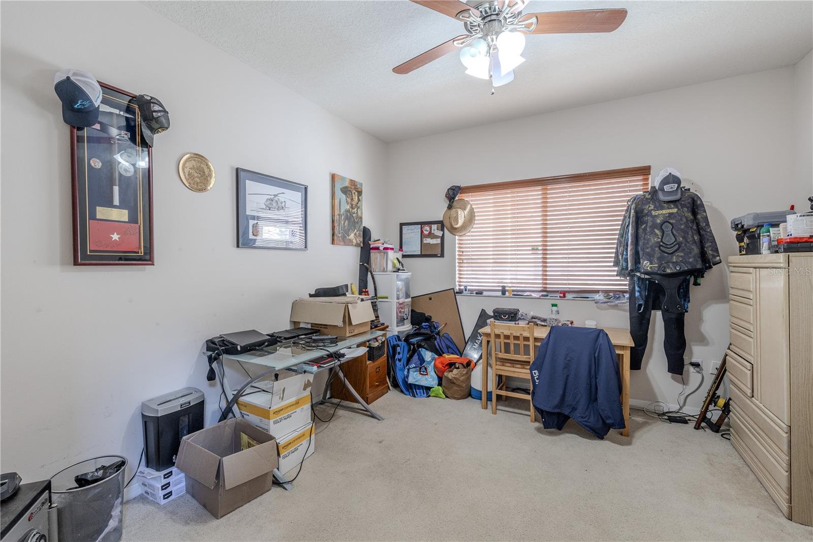 Office/Bonus Versatile den/bonus room with a ceiling fan and wide window offers flexible space for a home office, hobby room, or guest area.