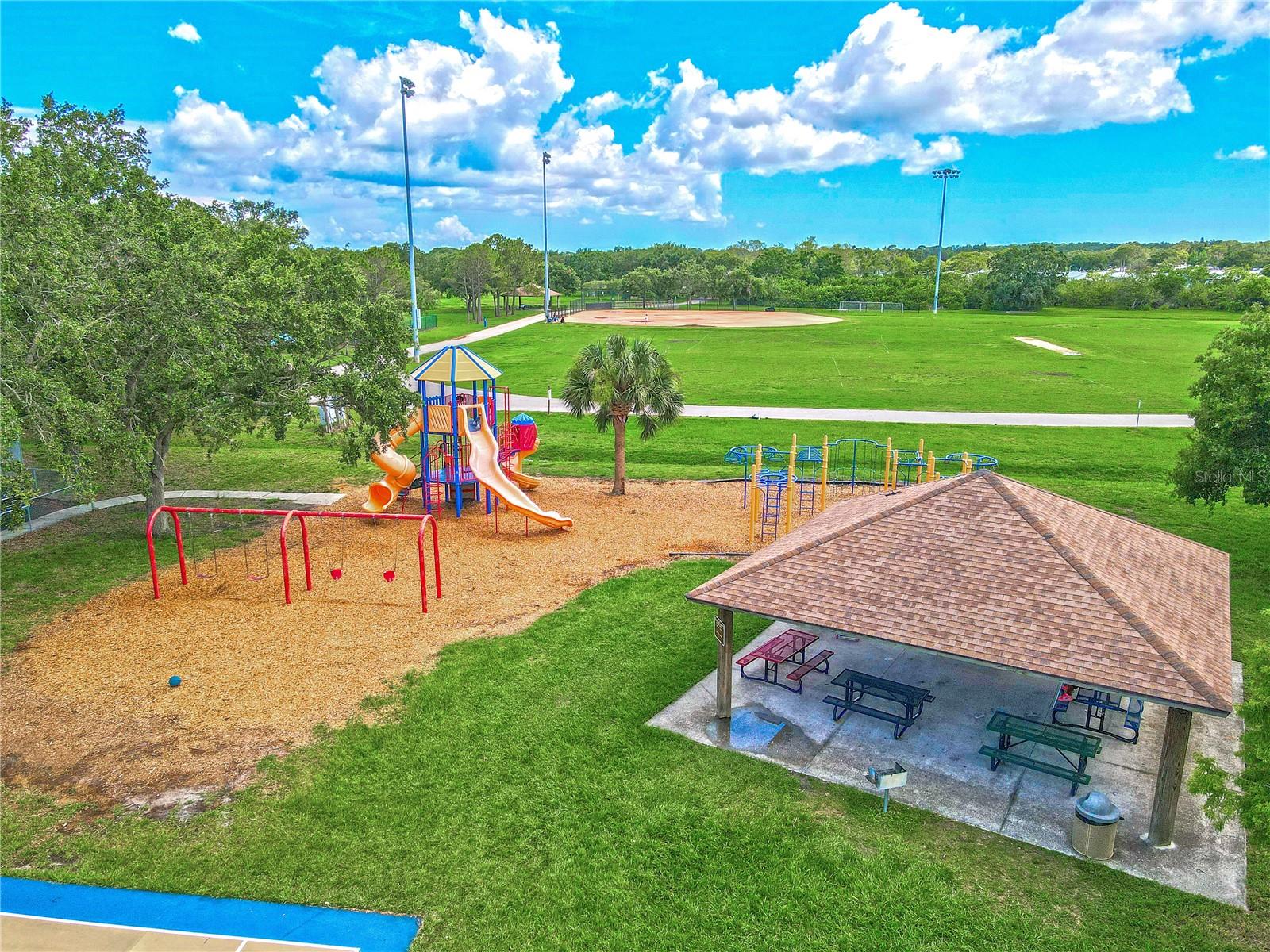 Nearby park offers a playground and covered picnic pavilion alongside open green space and ballfields—perfect for weekend fun and outdoor activities.