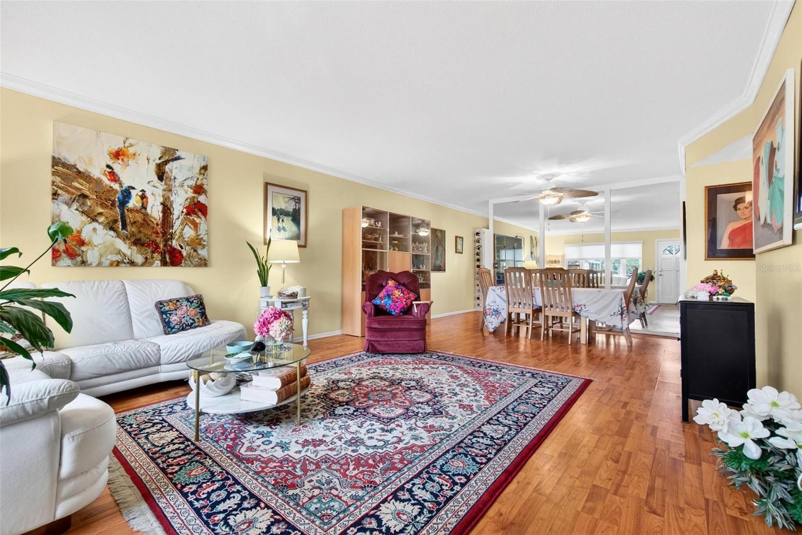 Living/Dining Combo with Beautiful Flooring and Crown Molding