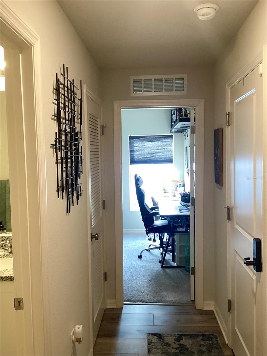 Bath #2 on the left. Garage entrance to the right. Bed #4 at end of hallway.