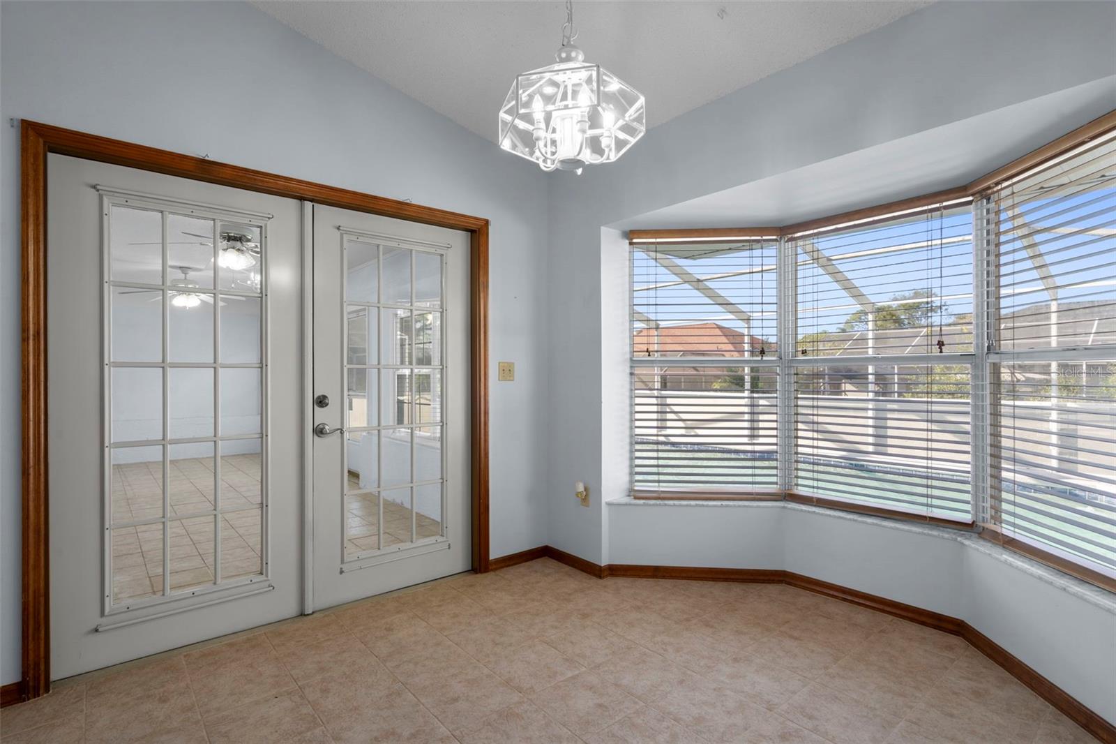 Breakfast nook with french door leading out to enclosed florida room