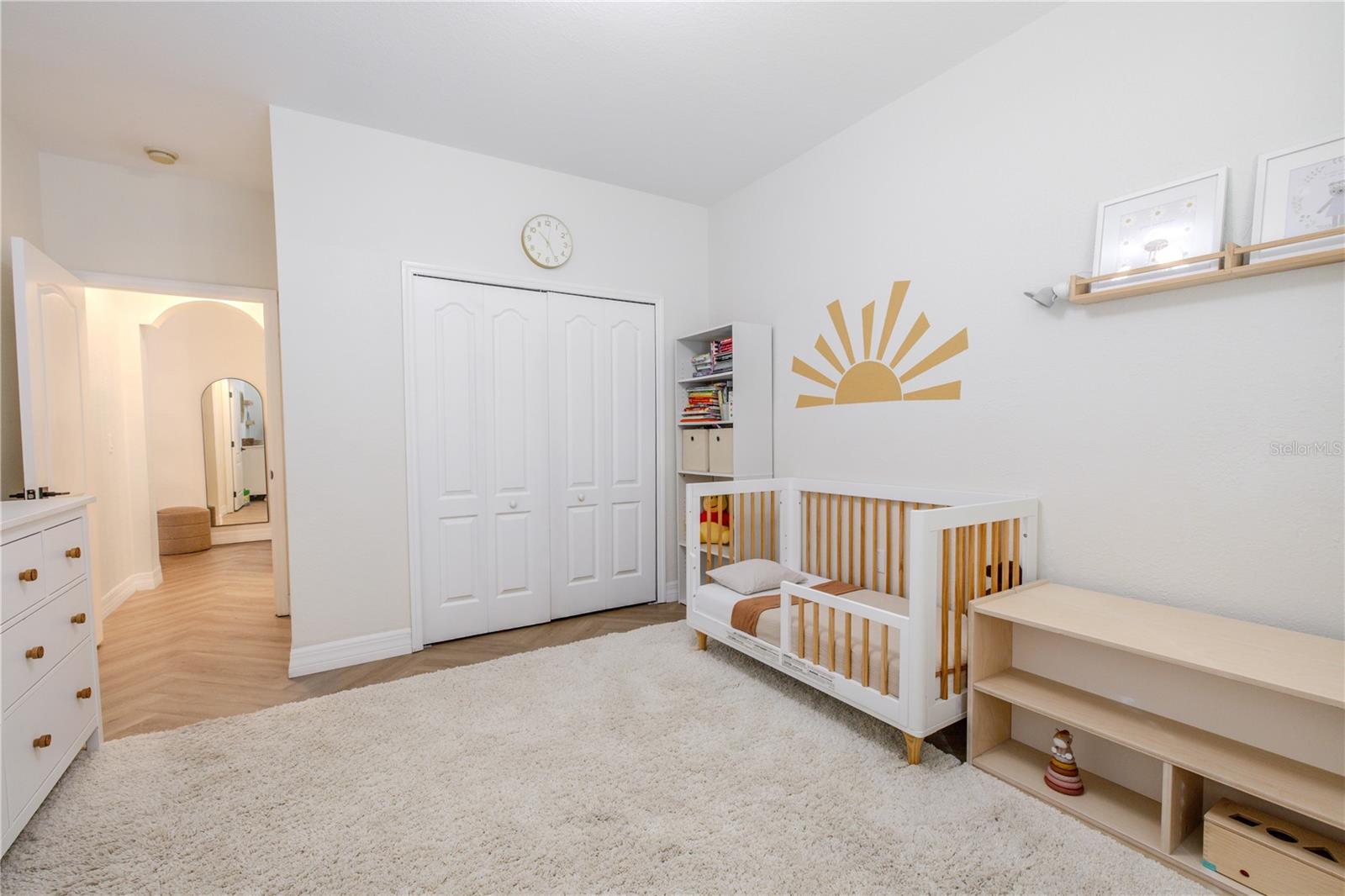 The second bedroom is bright & flexible, offering warm luxury vinyl flooring, neutral walls, built in closet & multiple windows w/wood blinds—perfect for a guest room, nursery, or home office.