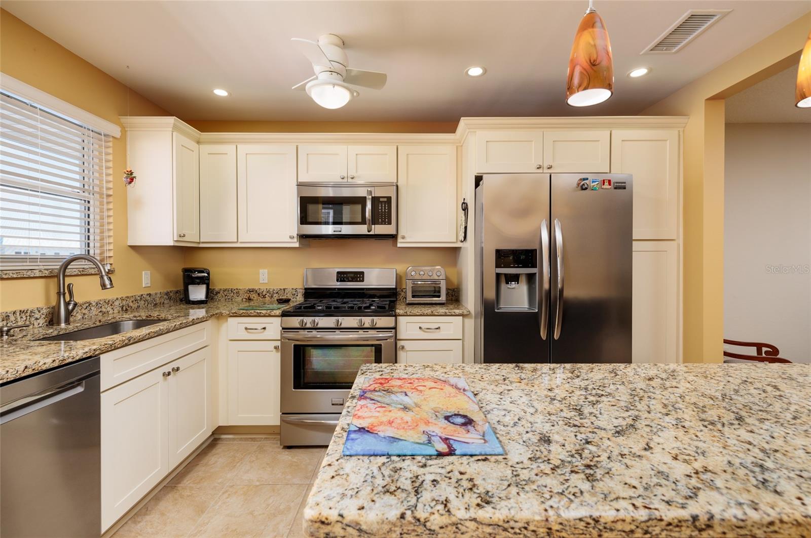 Open Kitchen w/gas range, convection oven & kitchen island.