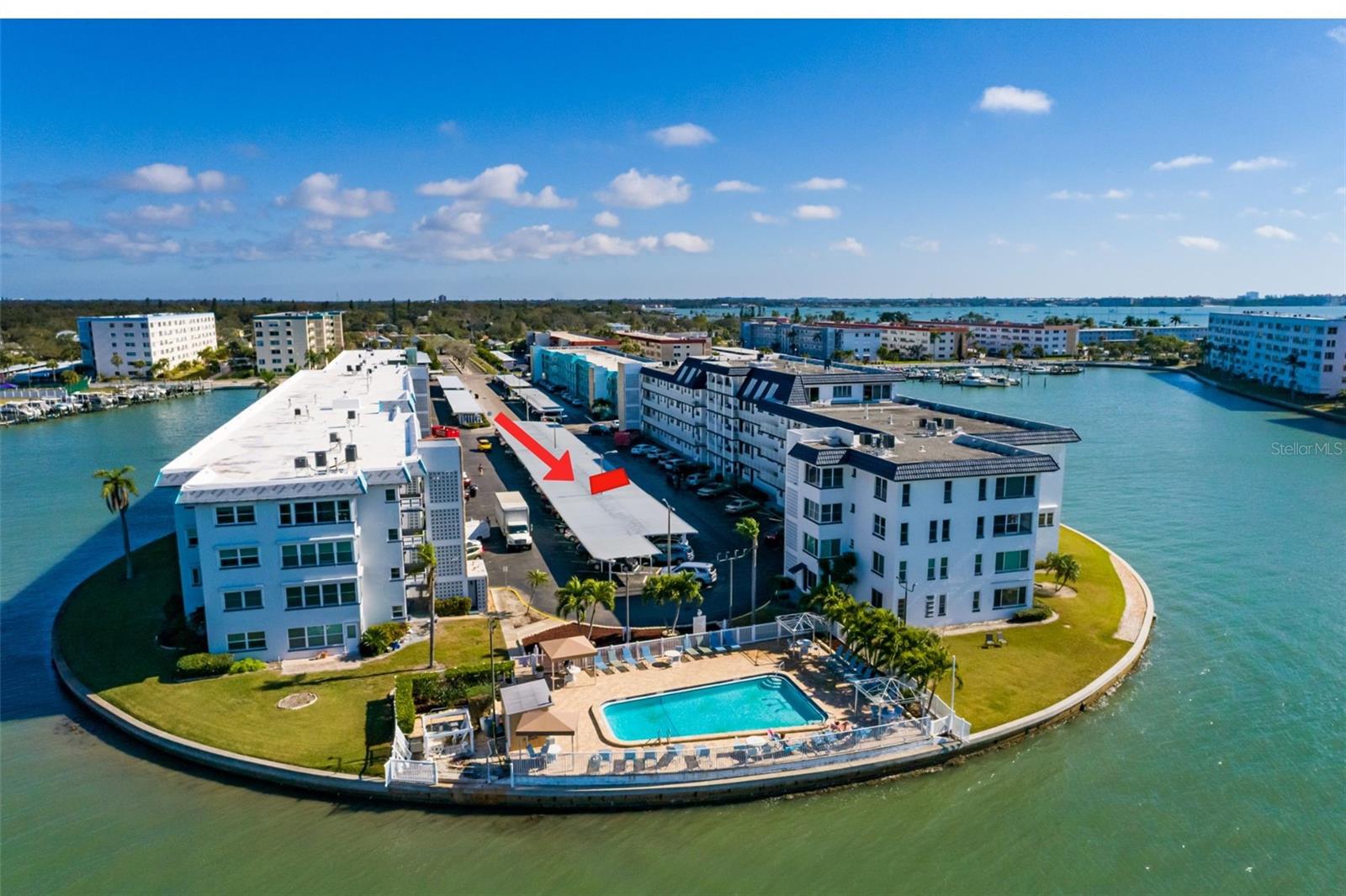 Carport #62 directly across from bldg entrance. Waterfront pool on west end.