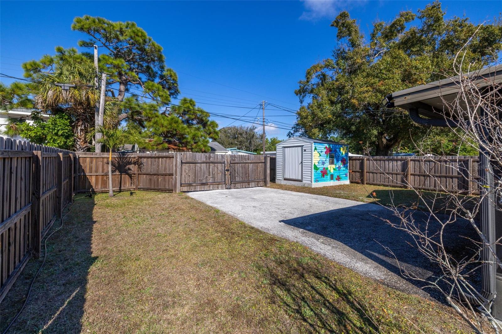 Large backyard with alley access and gates open and easy storage for RV, boats cars and more. Also ample room for a pool and yard is fenced already too and shed has power.