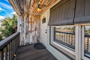 expensive and special composition deck panel, sensor lights, window awning, washed lumbers with custom caved anchor picture in front of entry door