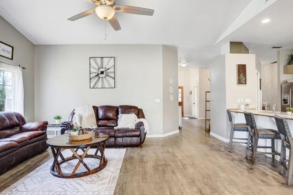 Living Area with beautiful mantel, wood burning fireplace and pocket sliders to the lanai