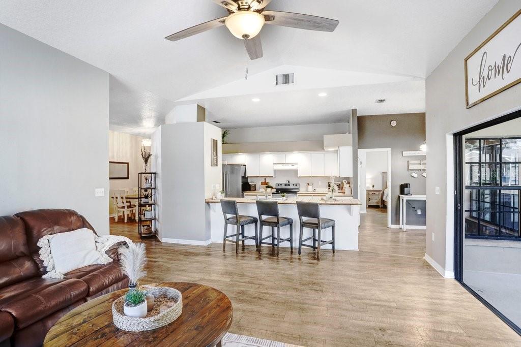 Living Area with beautiful mantel, wood burning fireplace and pocket sliders to the lanai