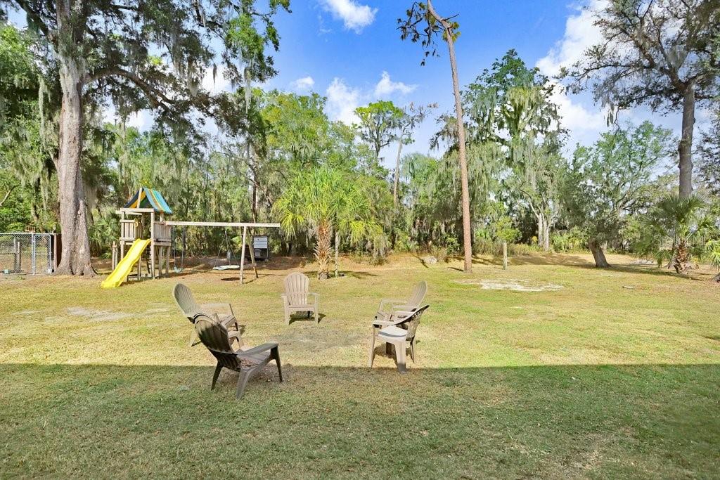 Back yard with play equipment, RV Port and Barn